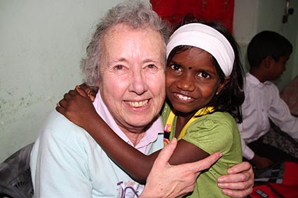 older woman hugging young girl