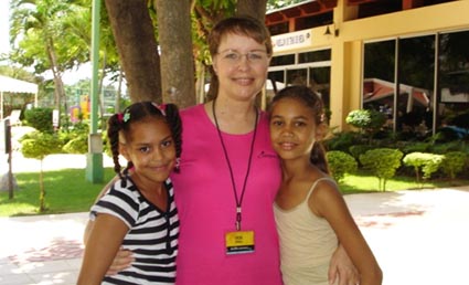 woman embracing two girls