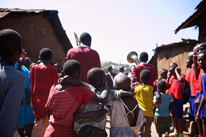 A group of children walking through a slum
