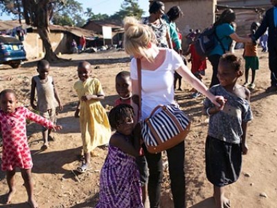 woman standing in the middle of a group of children