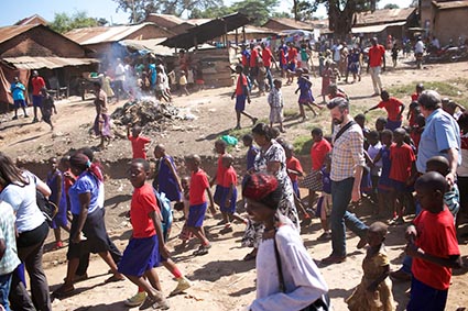 A group of people walking through a slum