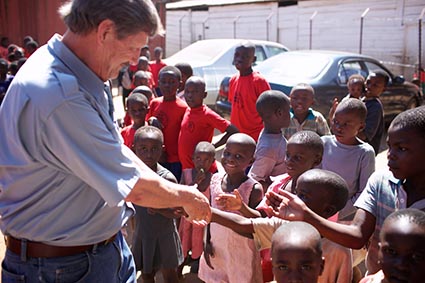 Wess Stafford with a group of children