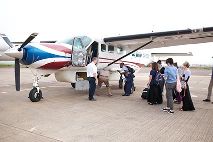 group of people boarding a small plane