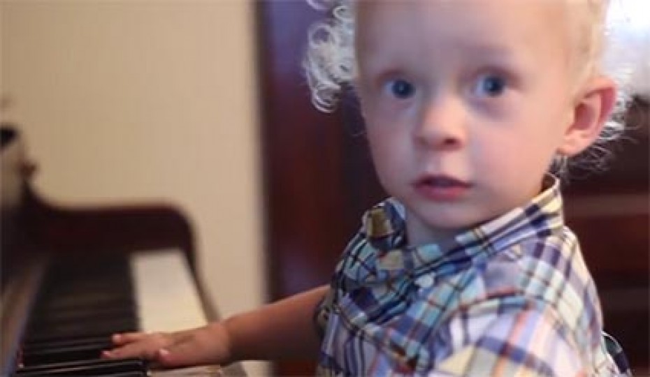 small child playing at piano