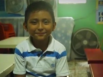 Young boy sitting at a table.