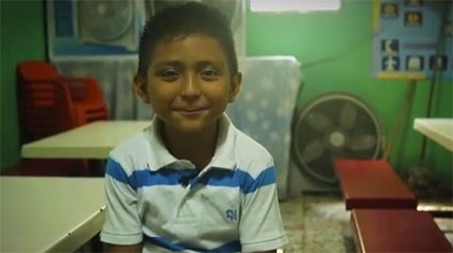 Young boy sitting at a table.