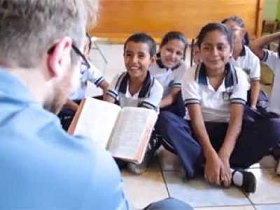 children sitting on floor listening