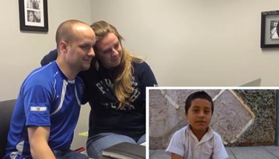 man and woman with inset photo of young boy