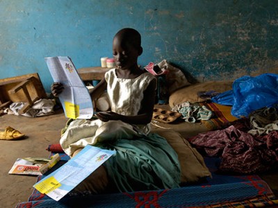 Child holding a letter.