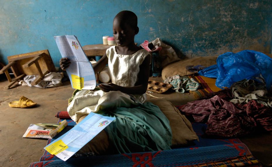 Child holding a letter.