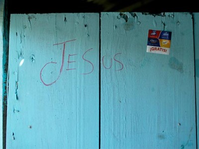 A blue wall with the word Jesus written on it