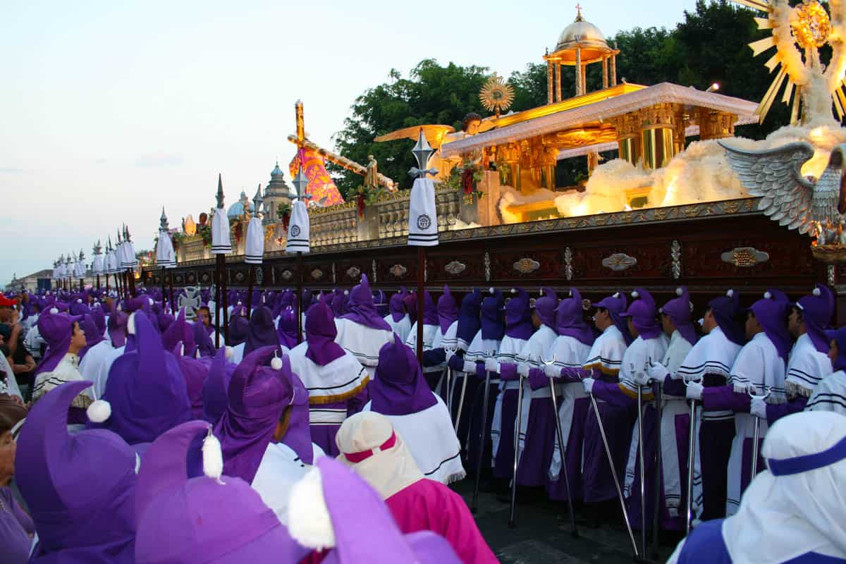 Easter in Guatemala parade with many men carrying a dais