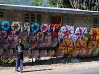 Easter in Haiti boy standing in front of kites