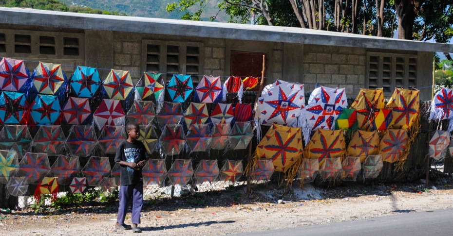 Easter in Haiti boy standing in front of kites
