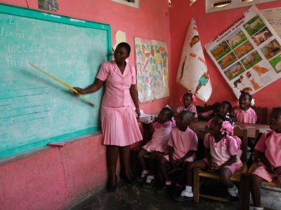 woman teaching children in a classroom