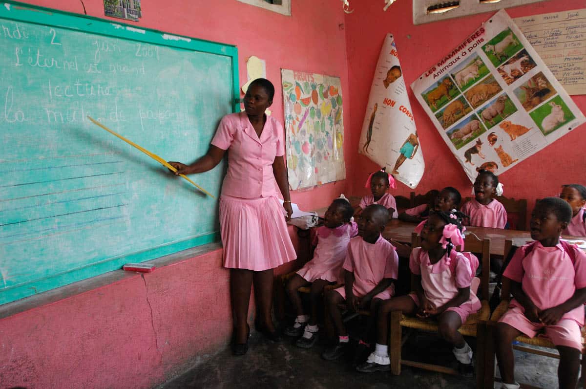 woman teaching children in a classroom