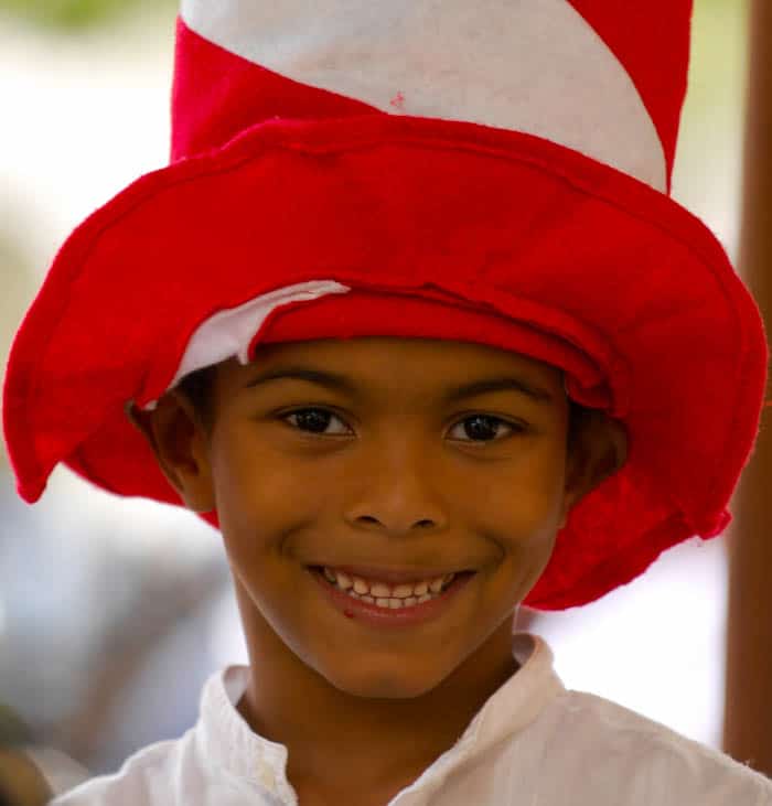 A child wears a Dr. Seuss hat