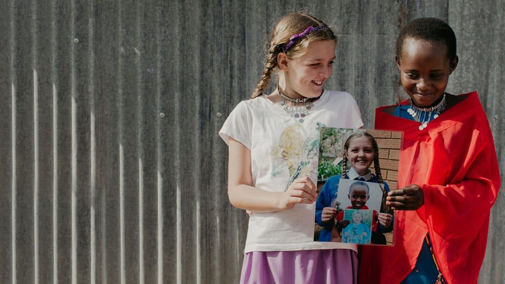 two girls holding photos