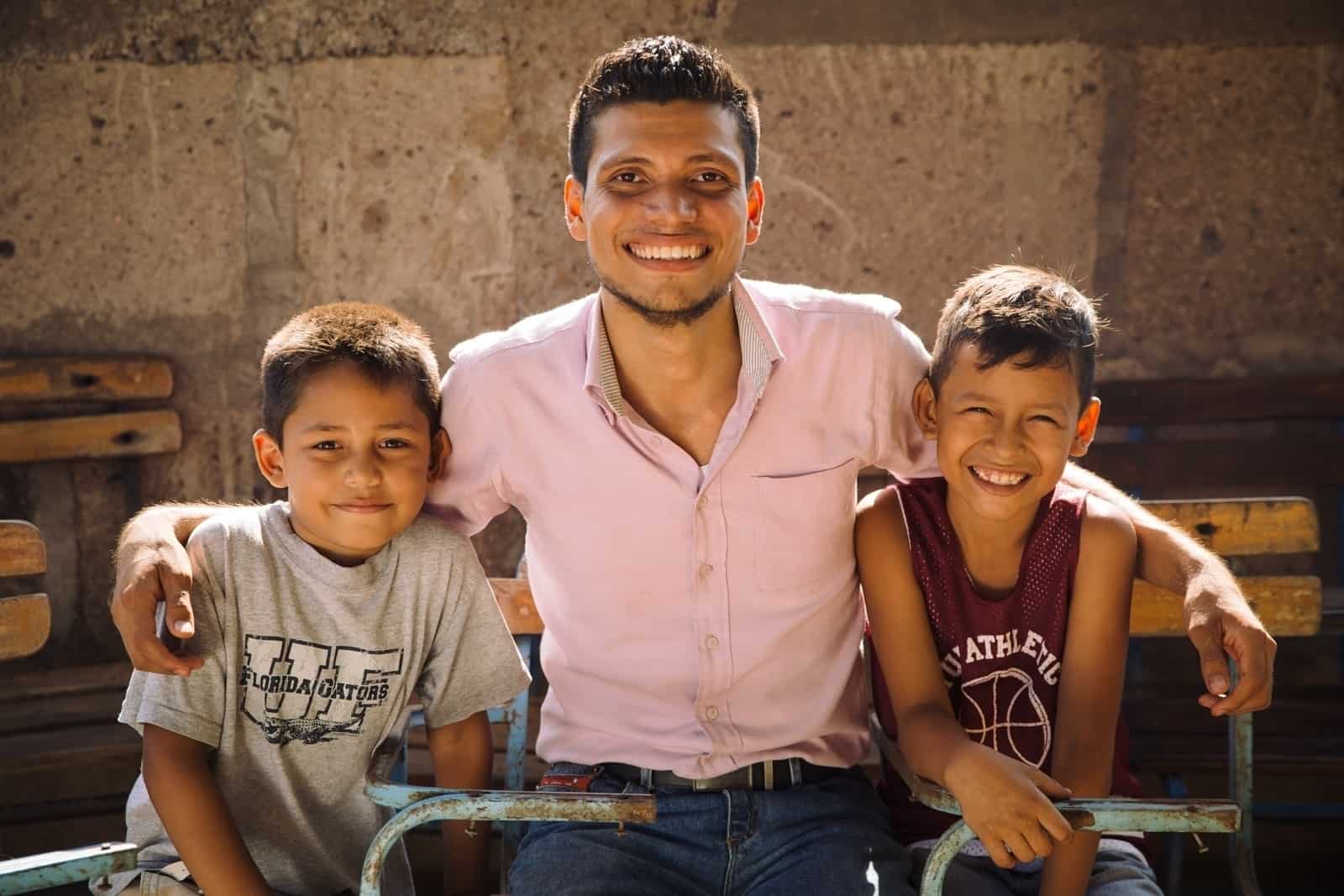 young man between two young boys