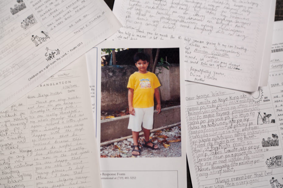 sponsor letters around a picture of a boy wearing an orange shirt and white shorts