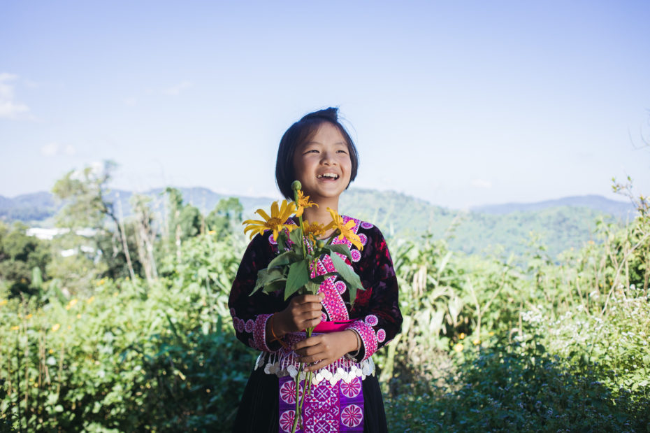 A little girl holding some flowers