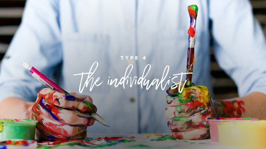 Someone sits at a table, holding paint brushes in each hand, covered in paint. Text: Type 4: The Individualist