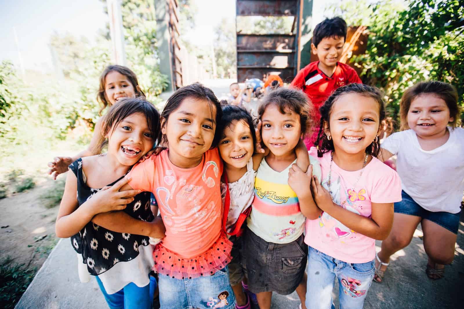 A group of children in Honduras smile for the camera.