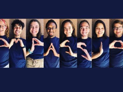 10 young people form the word 'Compassion' using their hands.