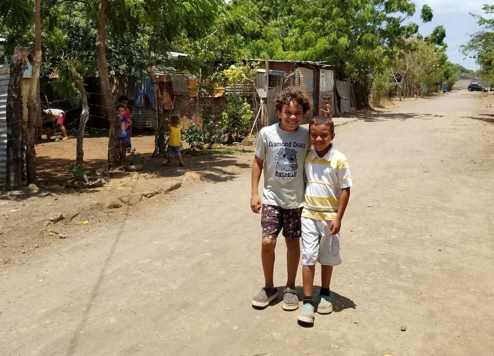 Two boys stand on a dirt road in Nicaragua.