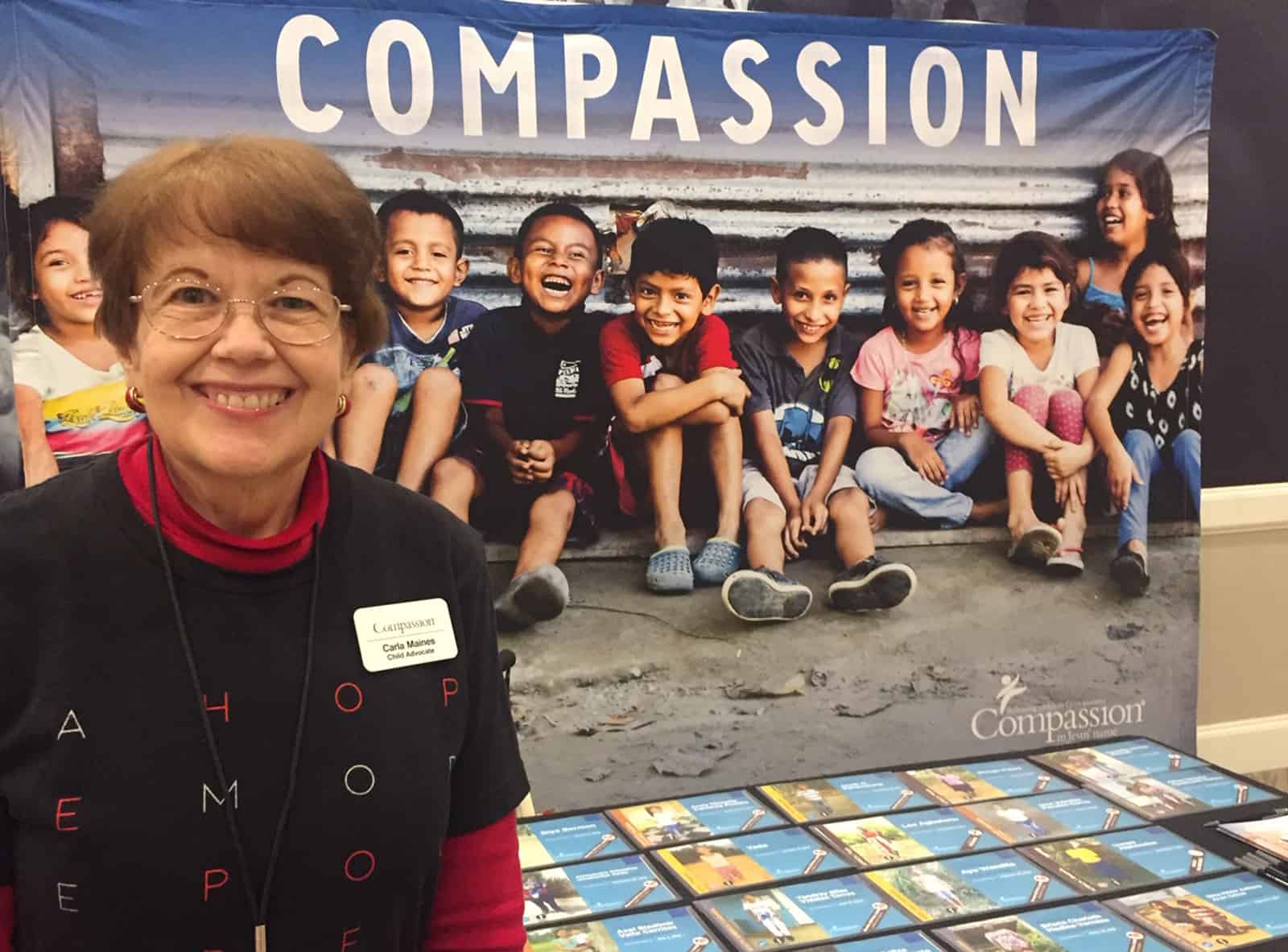 Carla Maines at a Compassion event table