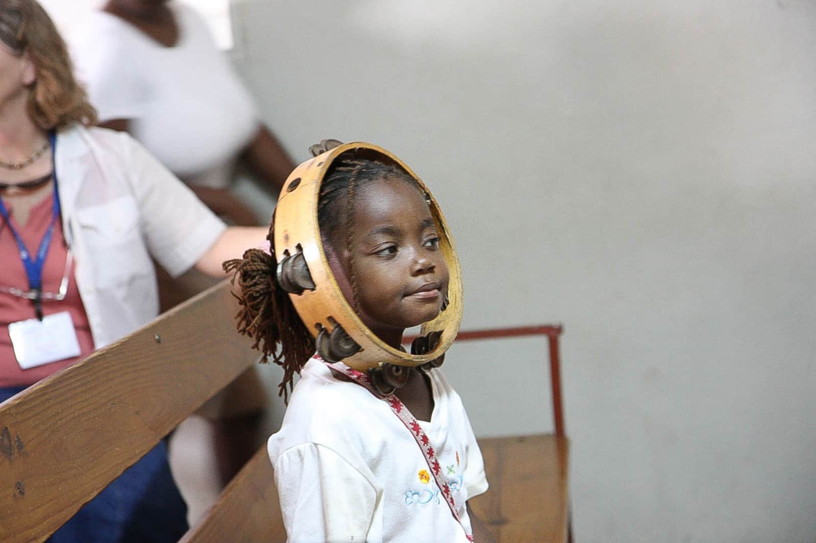 Cute little girl with a tambourine around her face