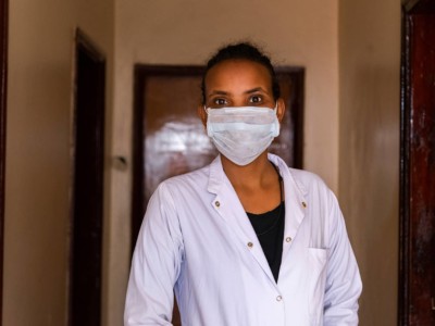 Dr. Addisalem Gebresilassie wearing scrubs and surgical mask