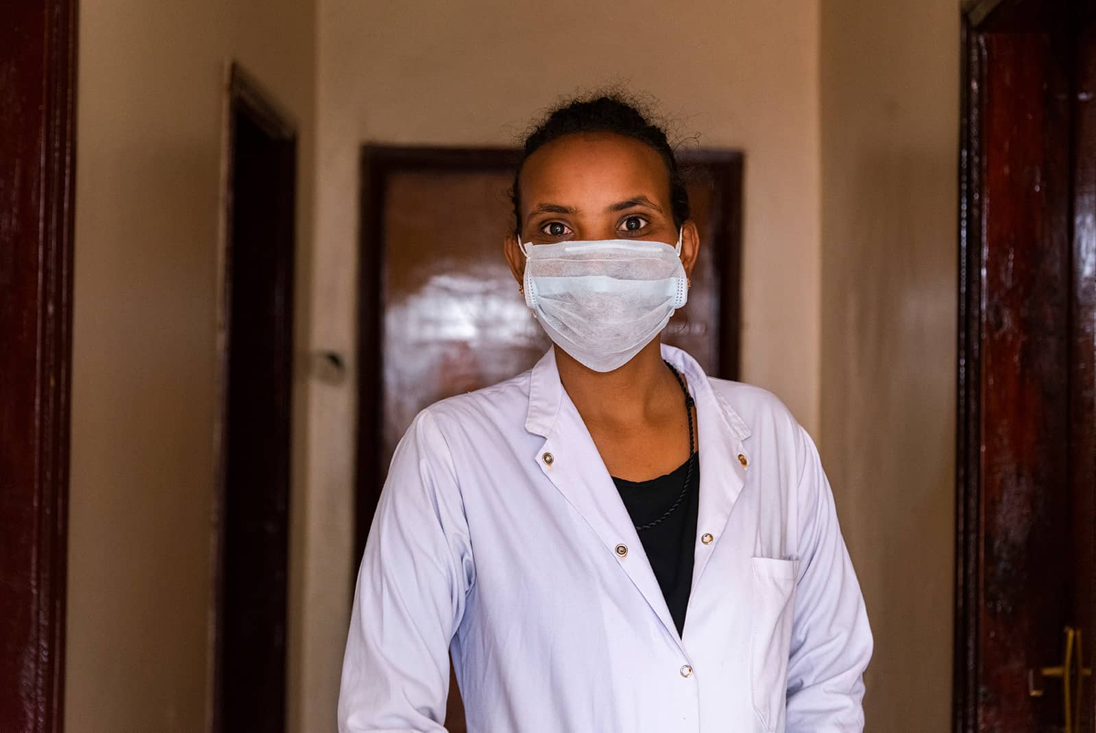 Dr. Addisalem Gebresilassie wearing scrubs and surgical mask