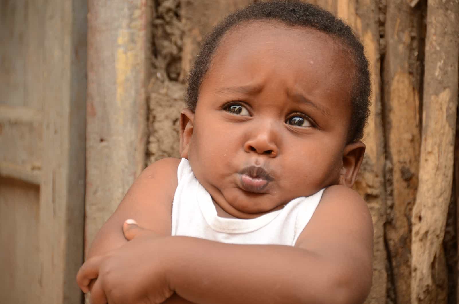Ethiopian toddler with arms crossed making a cute face