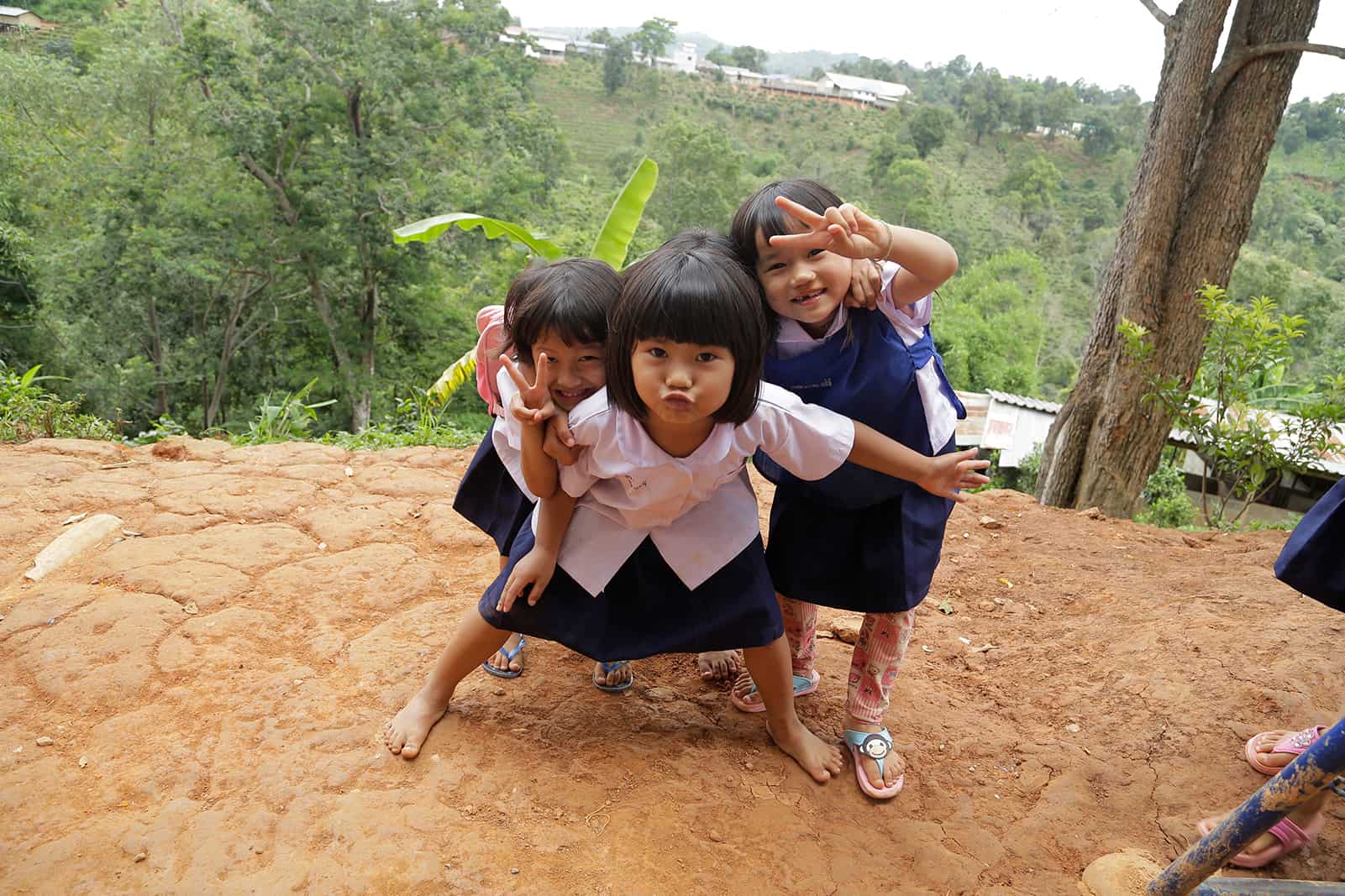 Grils in Thailand showing the peace sign