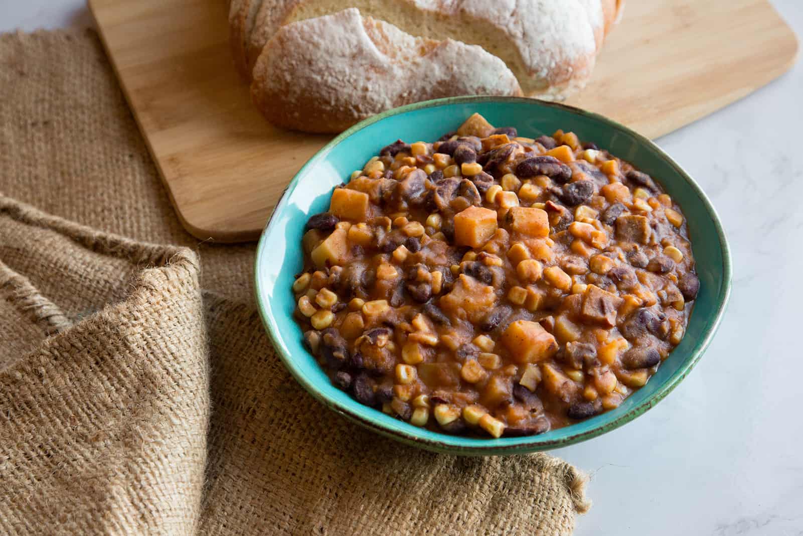 Githeri in a bowl with a loaf of bread