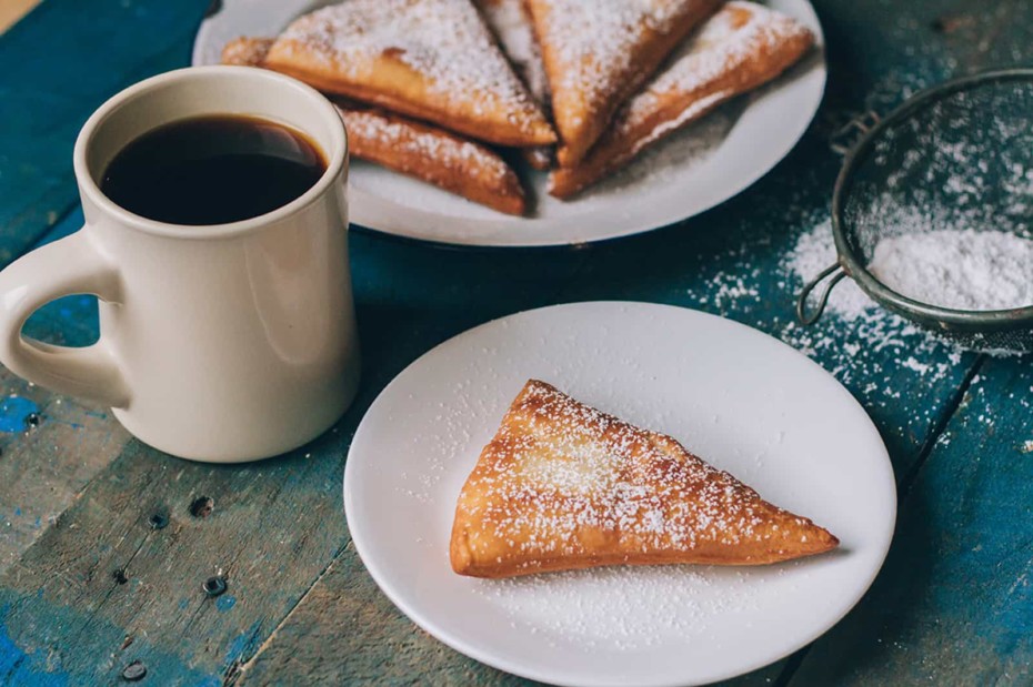 Rwandan Mandazi on a table with coffee