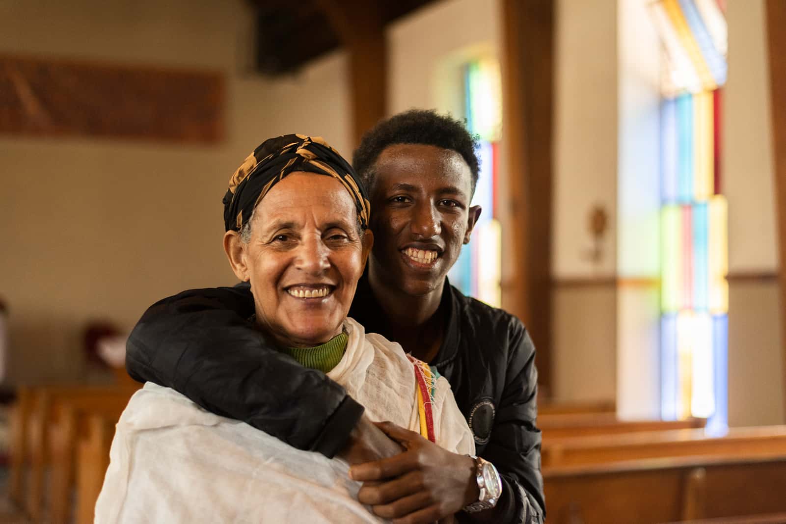 Son hugging mother in a church