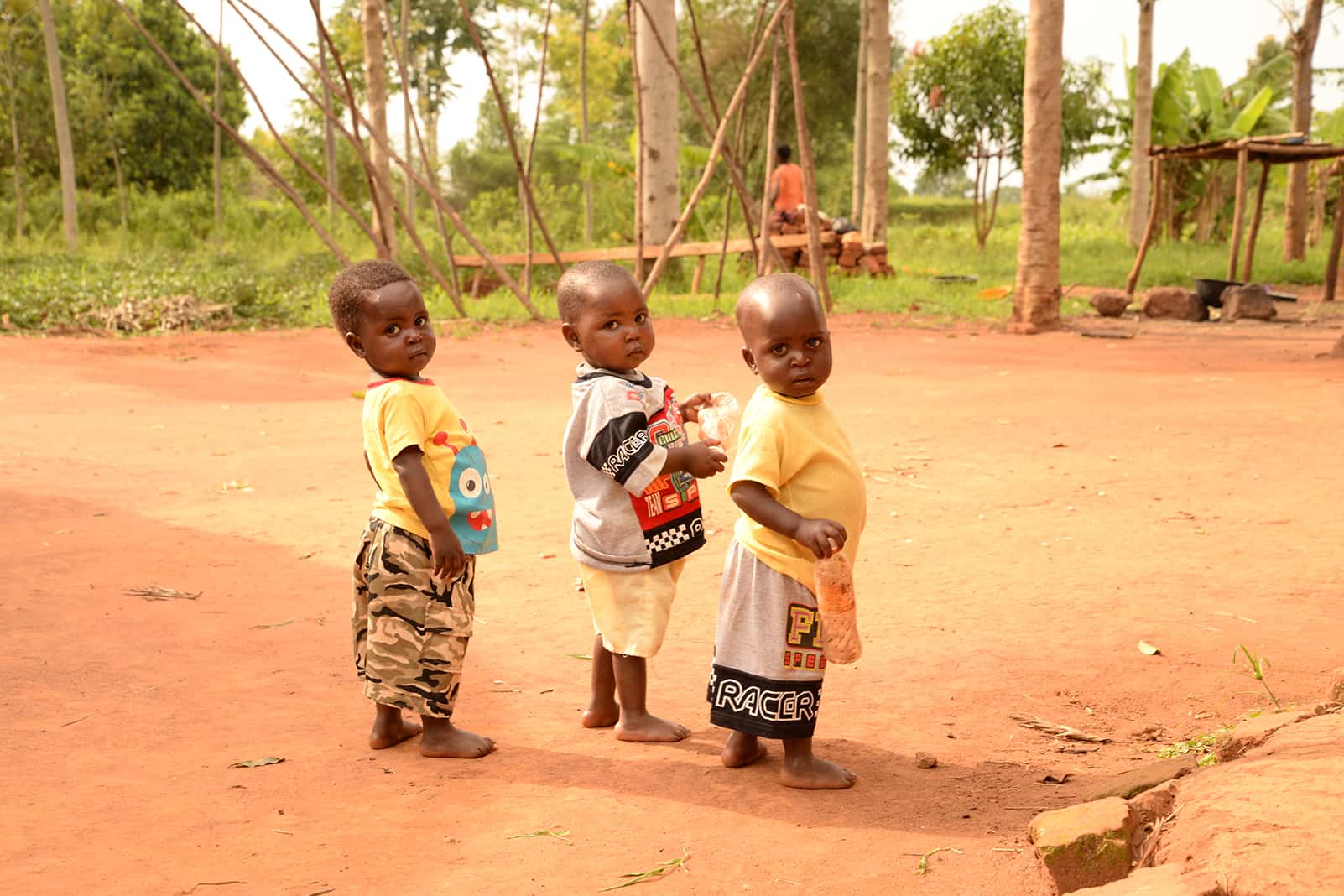 Toddler triplets on a dirt road in Uganda