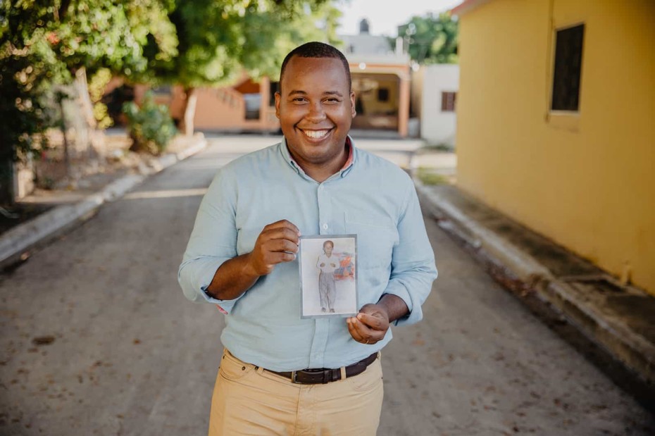 Tony Beltran holding a picture of himself when he was a child