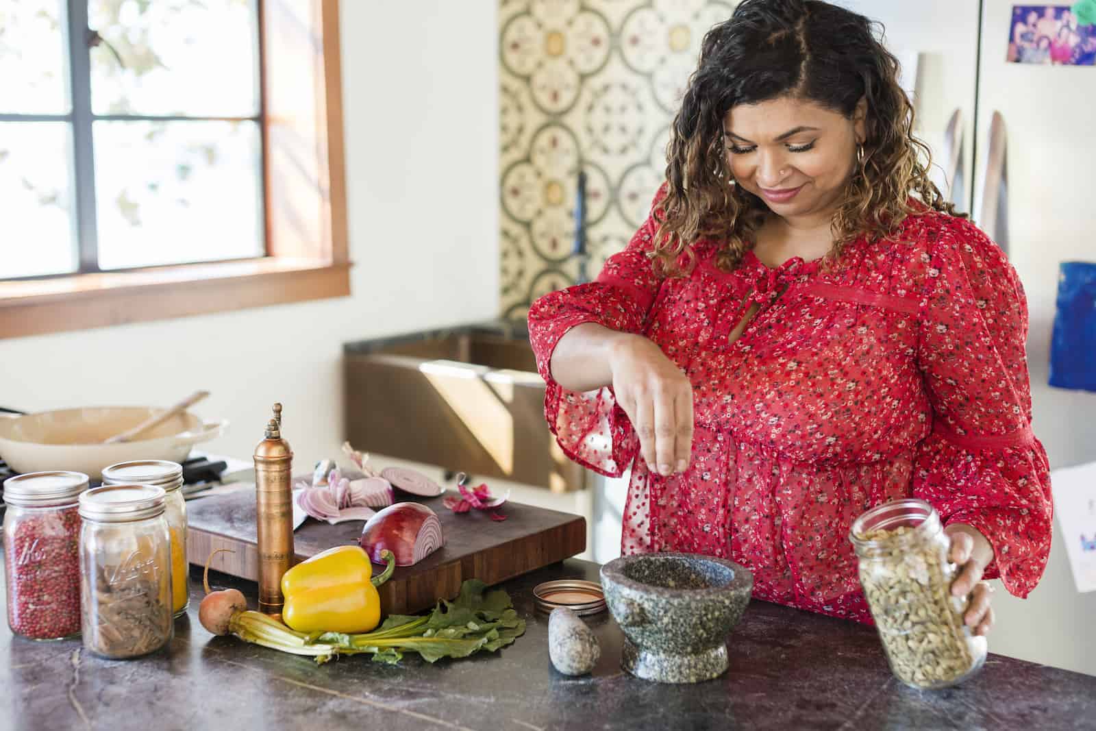 Aarti Sequeira cooks in a kitchen