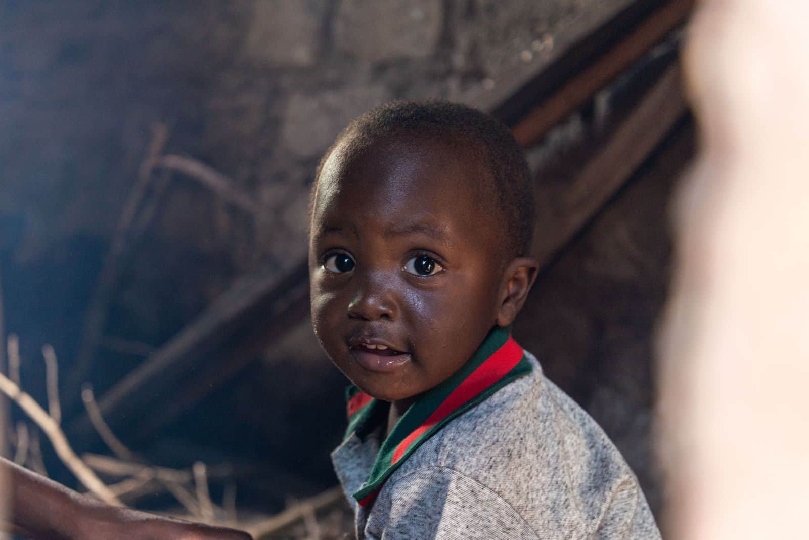 A young boy sits inside