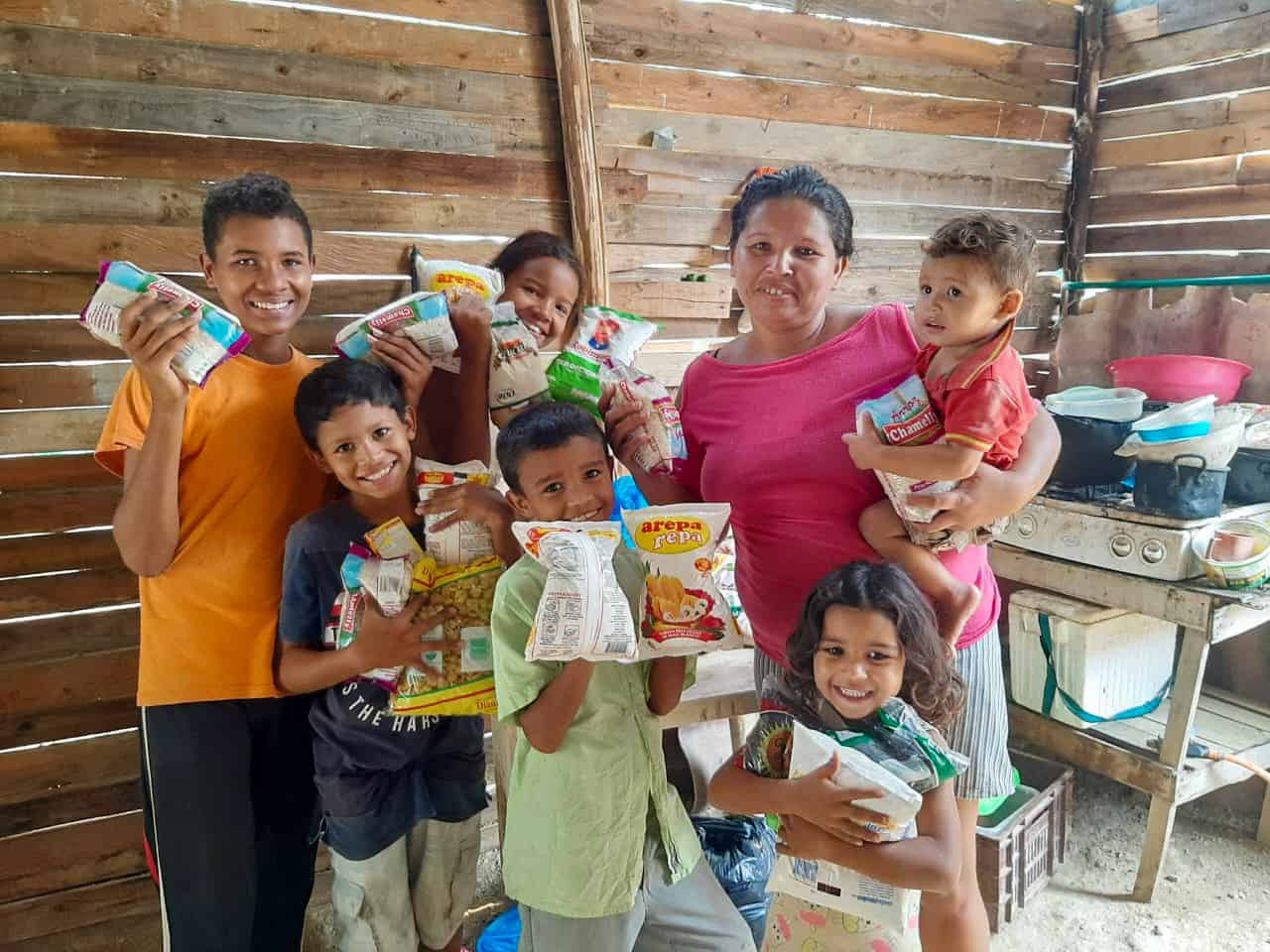 A family holds packages of food.