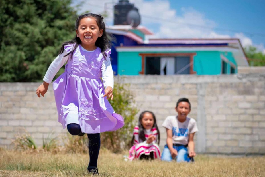 A girl runs toward the camera.