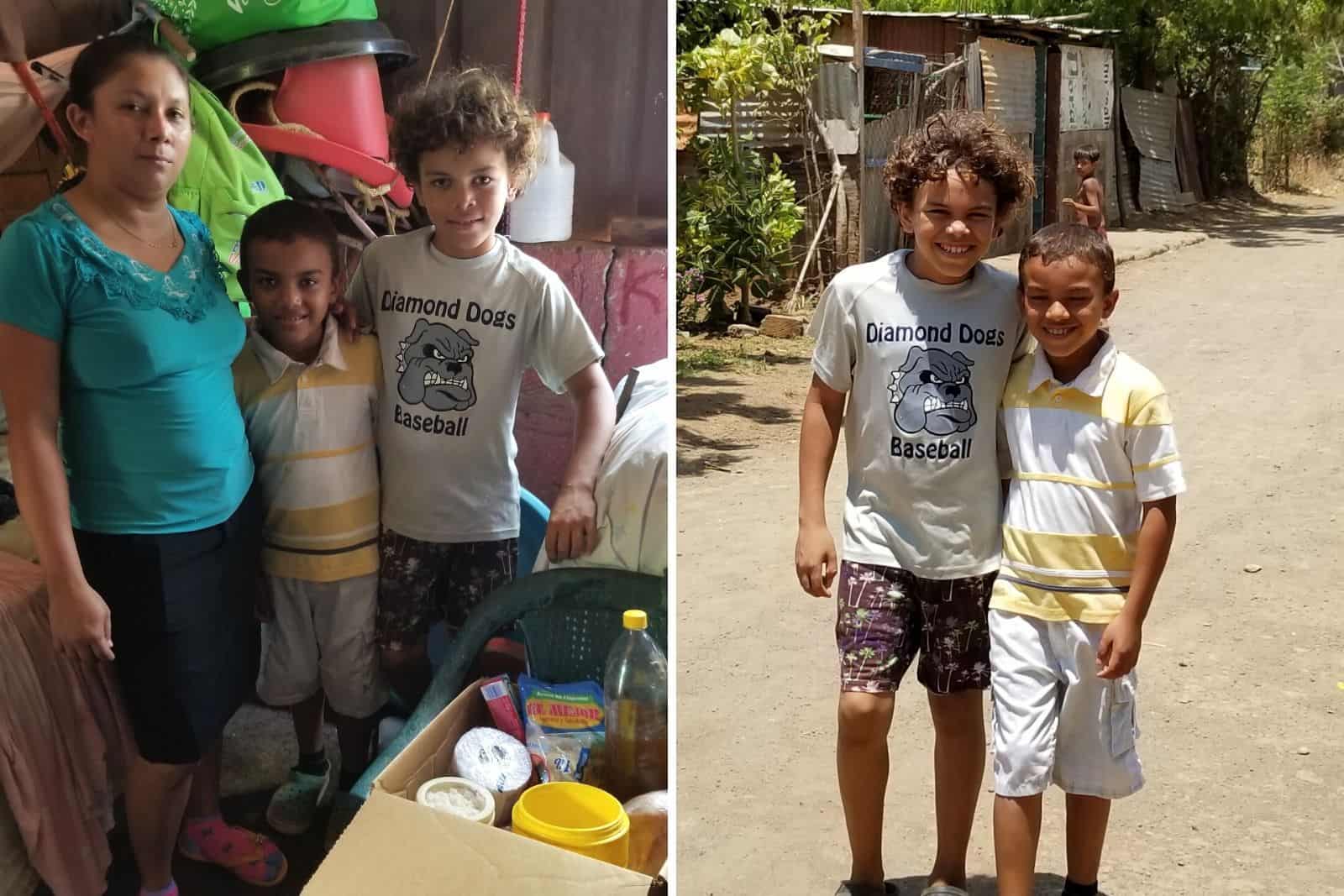 A woman and two boys stand in front of a box of food supplies