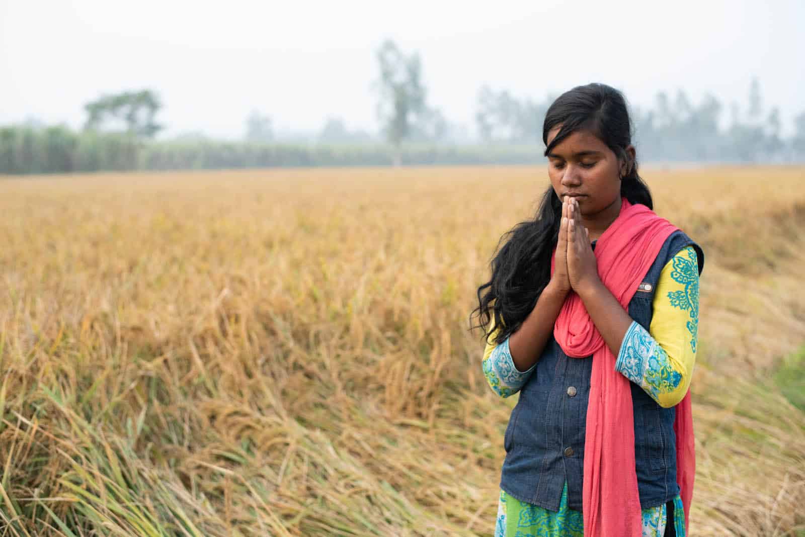 Angela praying in a field