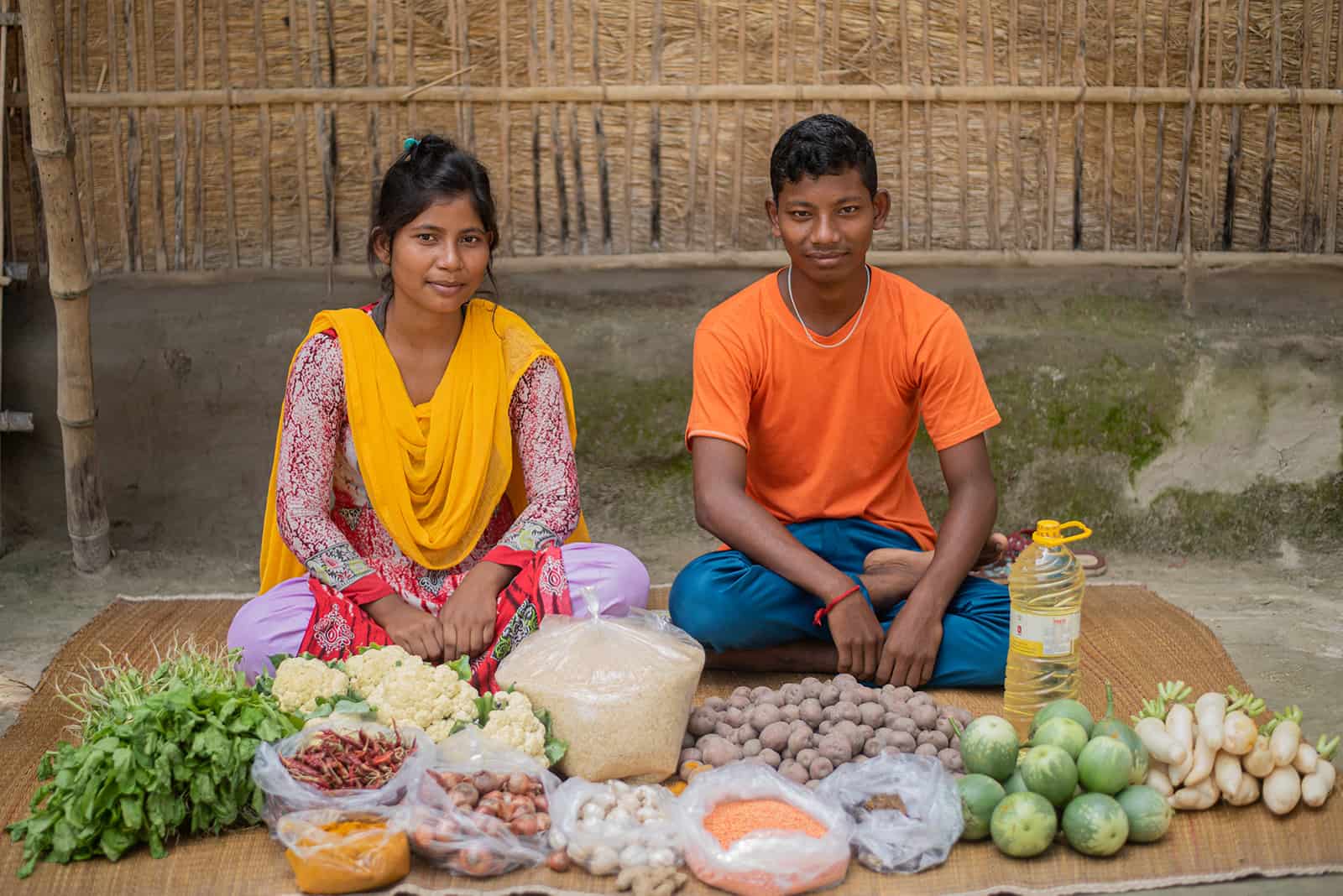 Eti and her brother with a week's worth of food