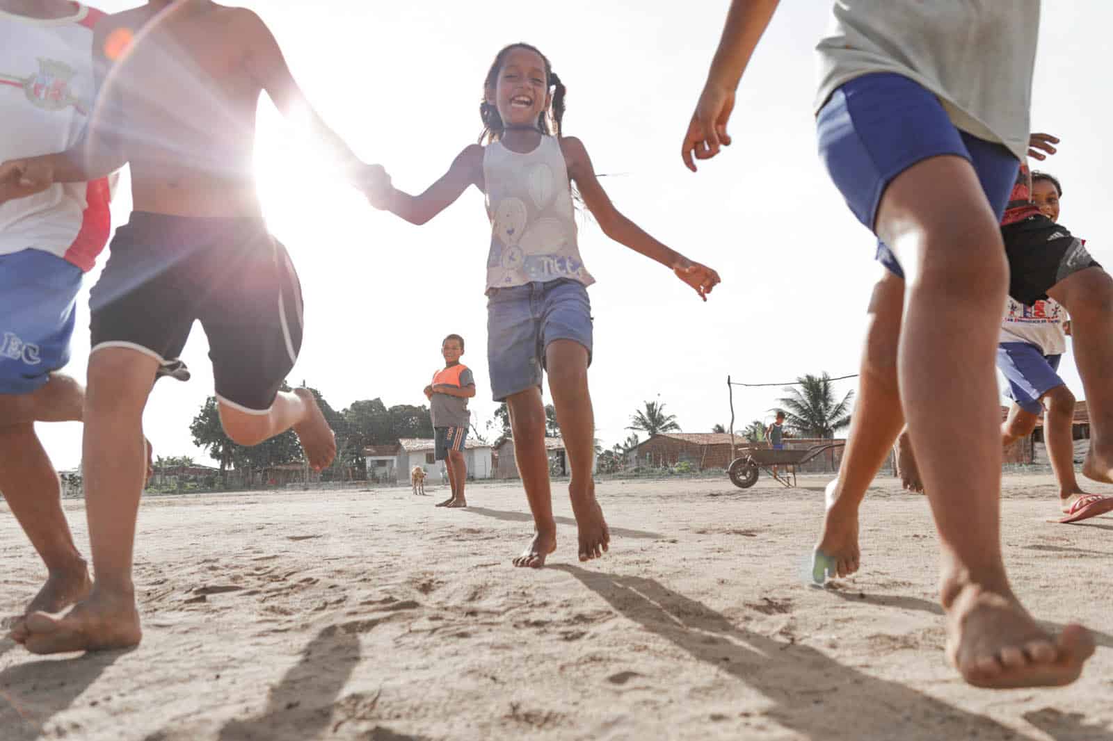 Klebiane running on sand with other children