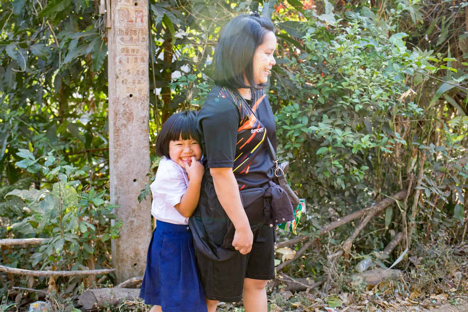 Sureeporn standing behind her mother giggling