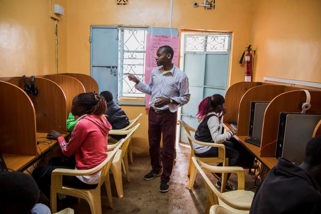 A man teaching computer sill class